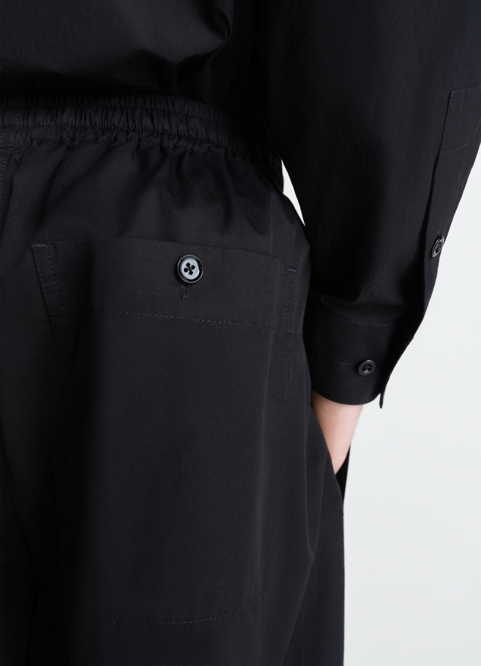 Lemaire pyjama pants in light cotton twill, model shot, back detail shot elastic waist button pocket