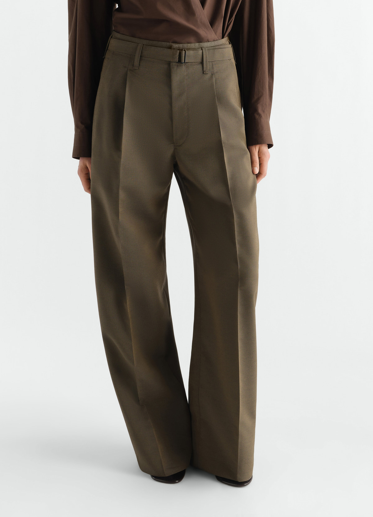 Wide pleated wool-mohair pants in olive green by lemaire worn by a model front view on white background