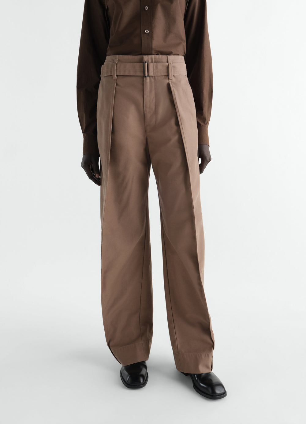 Rounded brown polycotton twill pants with belt detail worn by model front view LEMAIRE