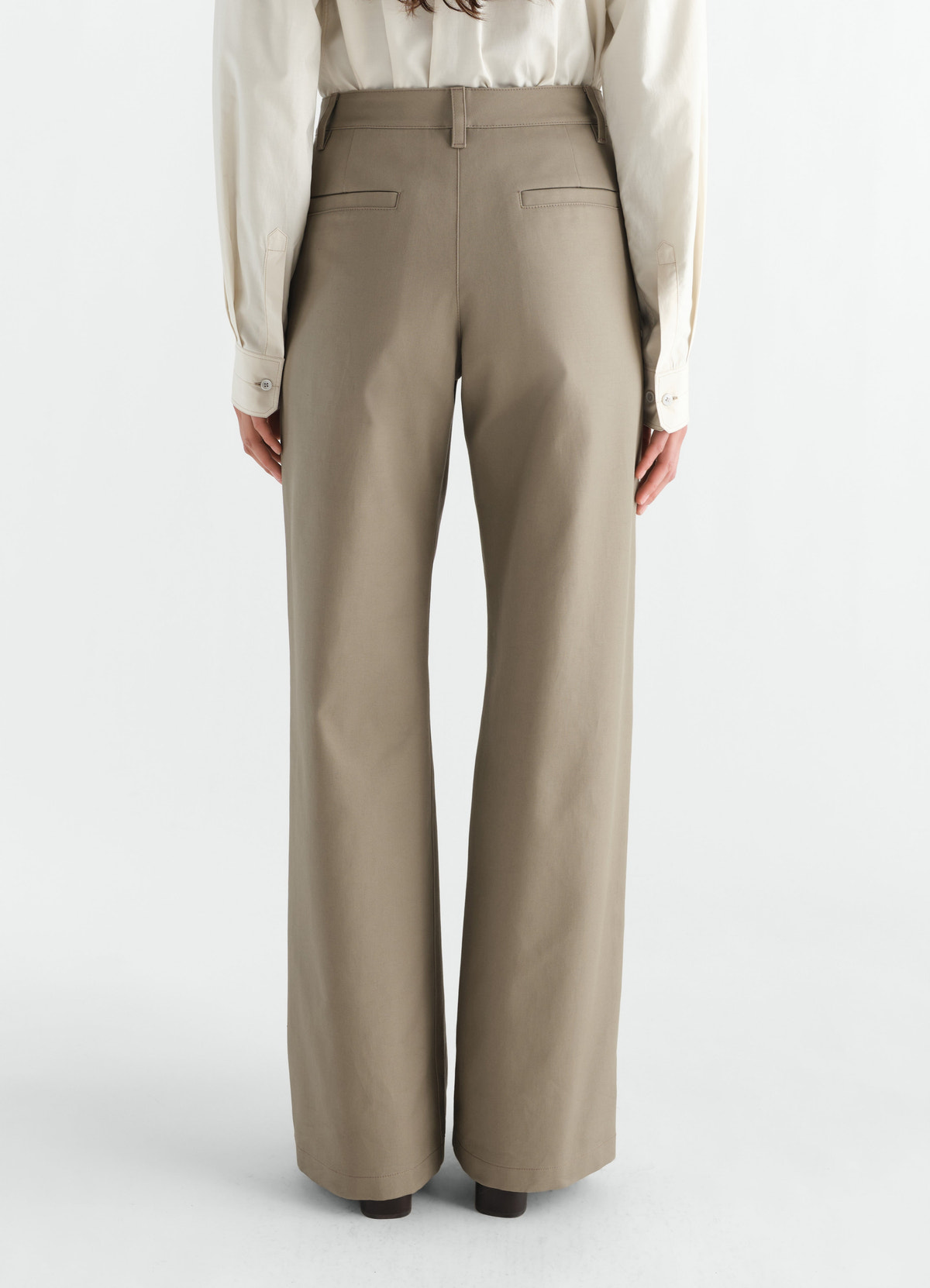 Straight heavy cotton twill pants in beige by lemaire worn by model back view with pockets and belt loops