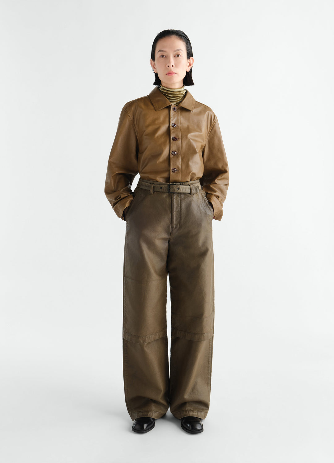 Work pants in coated broken twill dark olive worn by model front LEMAIRE