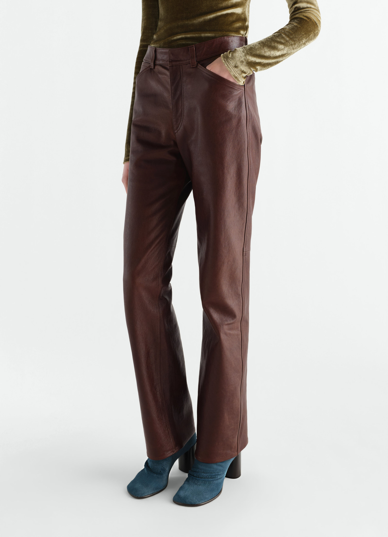 Straight brown glossy leather pants worn by model, side view, lemaire