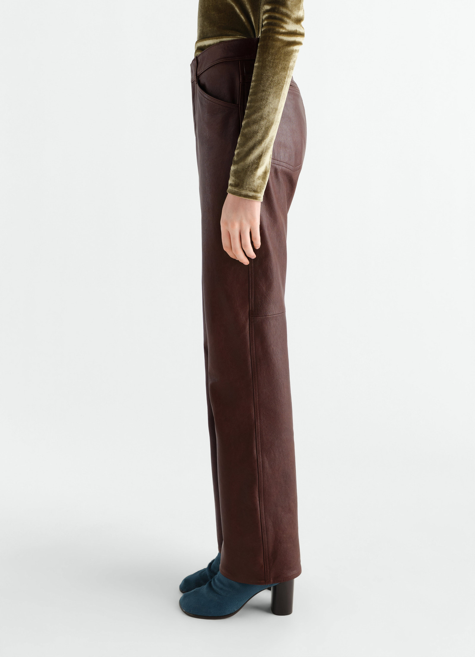 Straight glossy brown leather pants lemaire worn by model side view with high-waisted fit and patch pockets