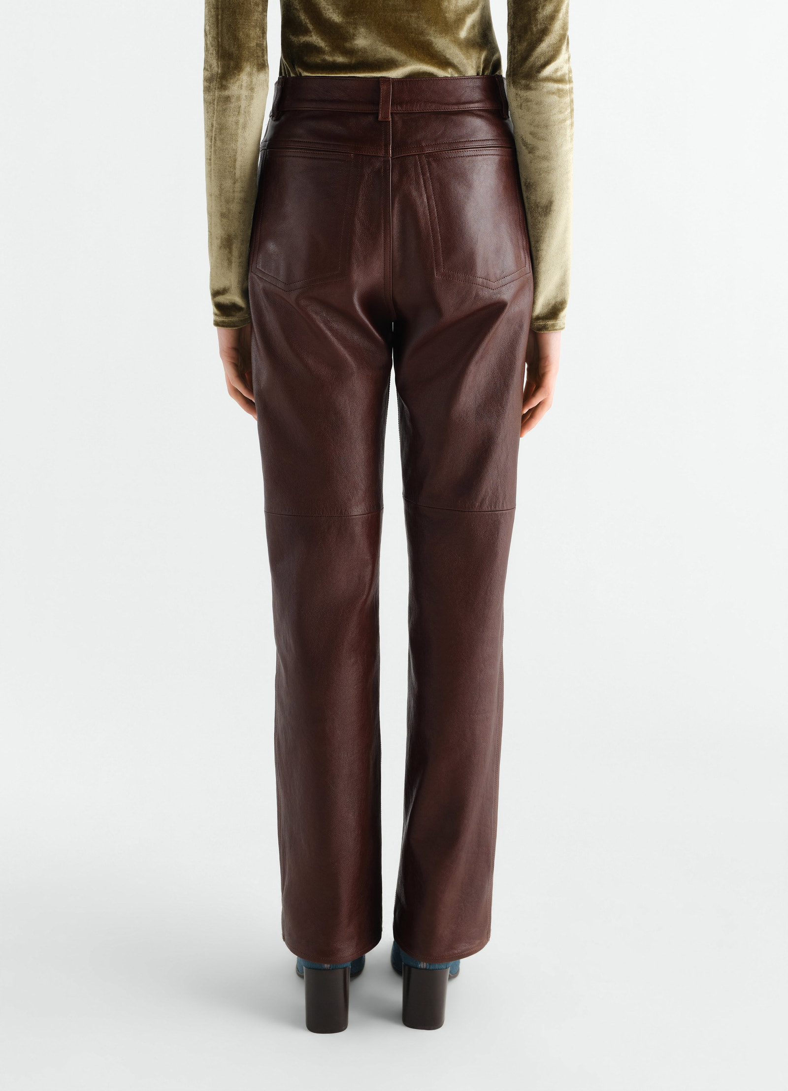 Straight brown glossy leather pants lemaire worn by model back view with pockets and belt loops