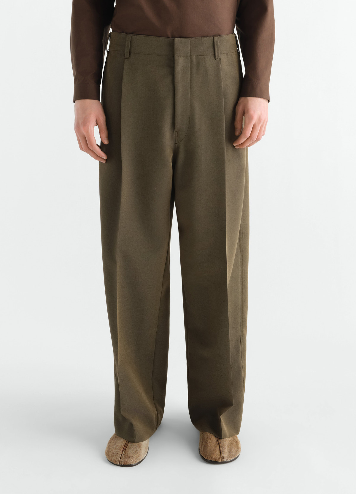 Single-pleat tailored wool and mohair pants in olive green worn by model front view lemaire