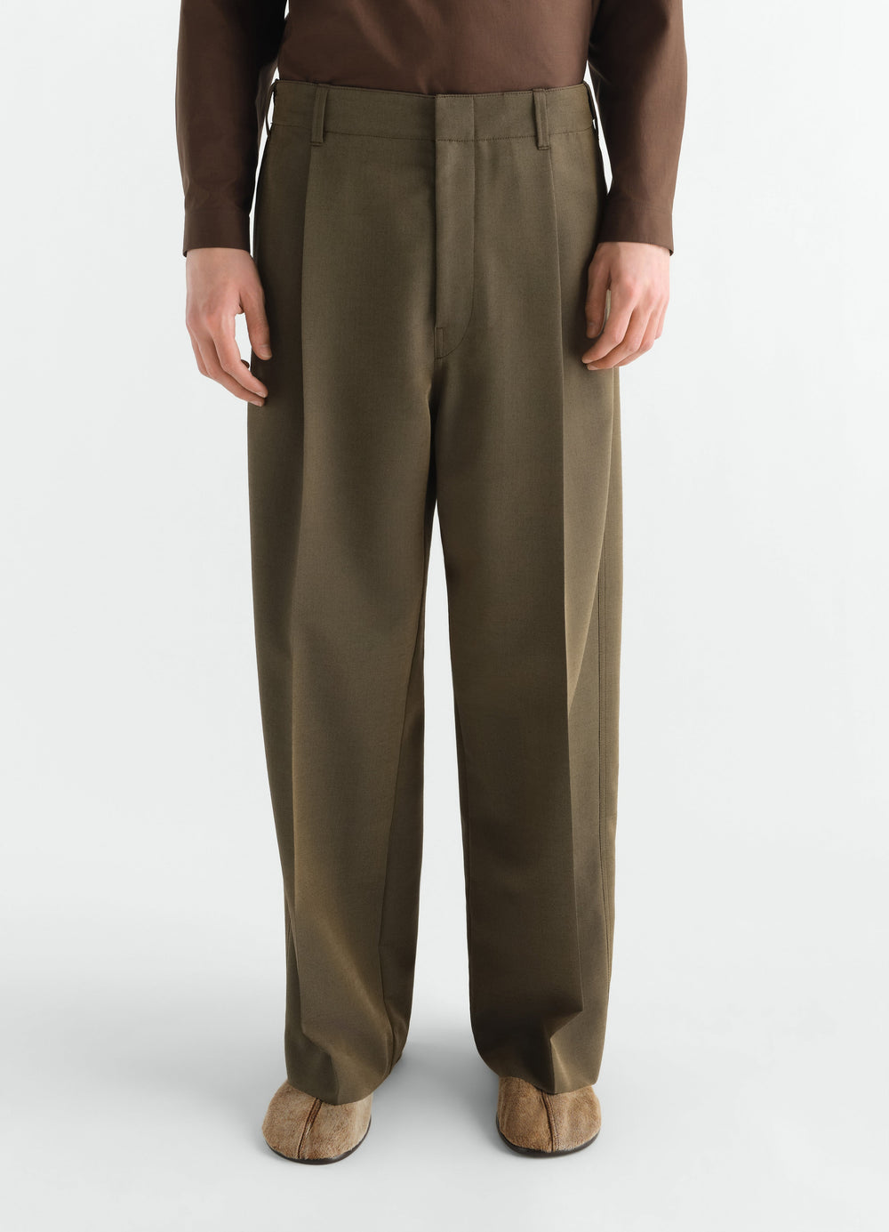 Single-pleat tailored wool and mohair pants in olive green worn by model front view LEMAIRE