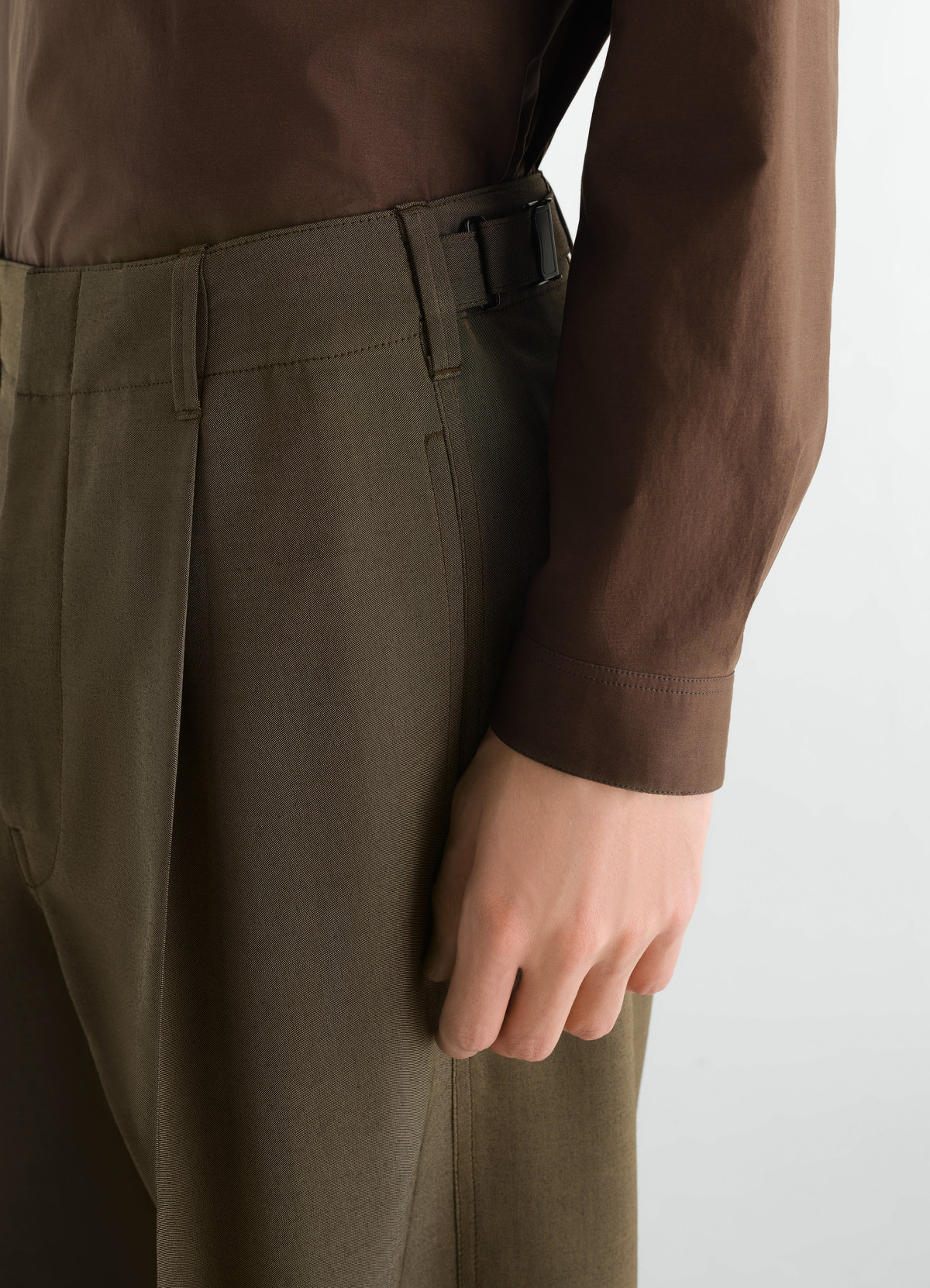 Single-pleat tailored wool mohair pants in olive green by lemaire close-up side detail worn by model