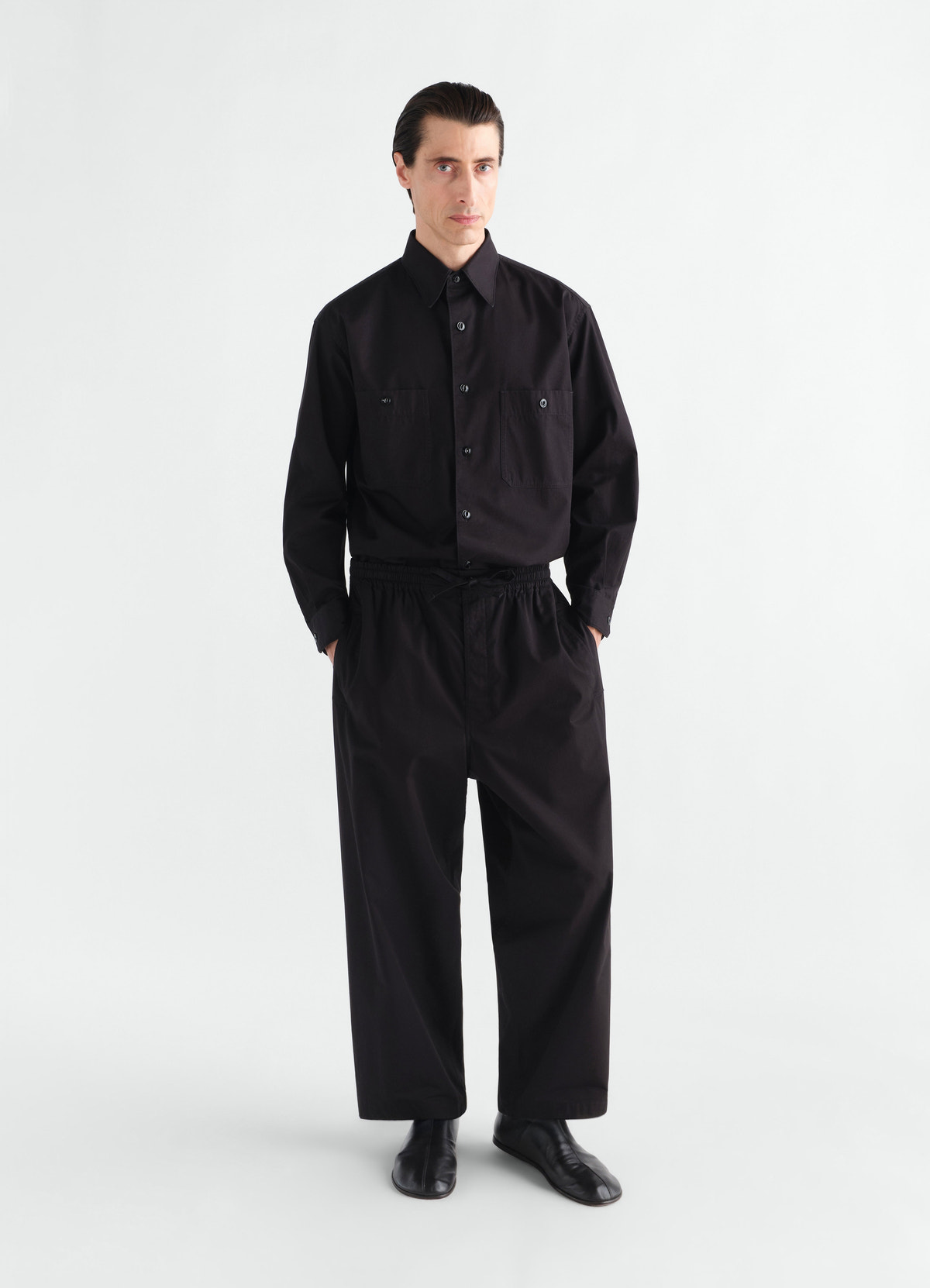 Pyjama pants in black light cotton twill worn by a model front view lemaire