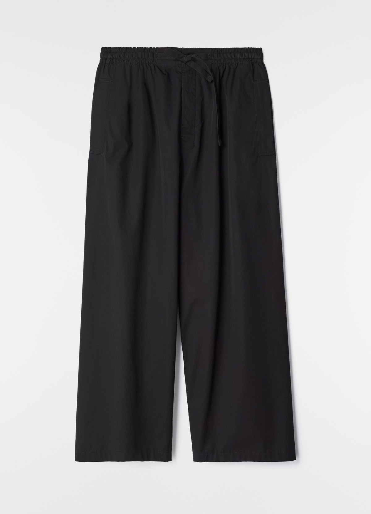 Pyjama pants lemaire black light cotton twill with elastic waist laid flat on white background