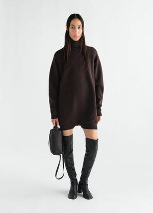 Relaxed brown felted merino wool jumpsuit by lemaire worn by model with black leather boots and bag front view