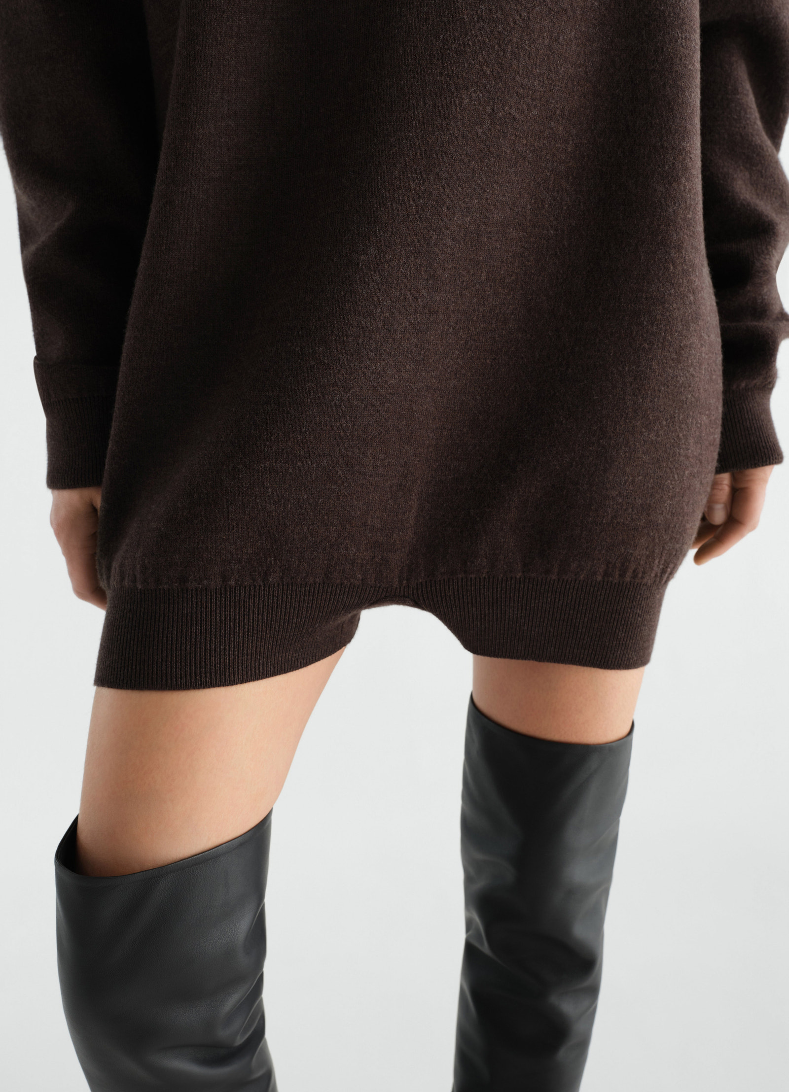 Relaxed felted merino wool jumpsuit in dark brown lemaire worn by model showing hem and sleeve detail
