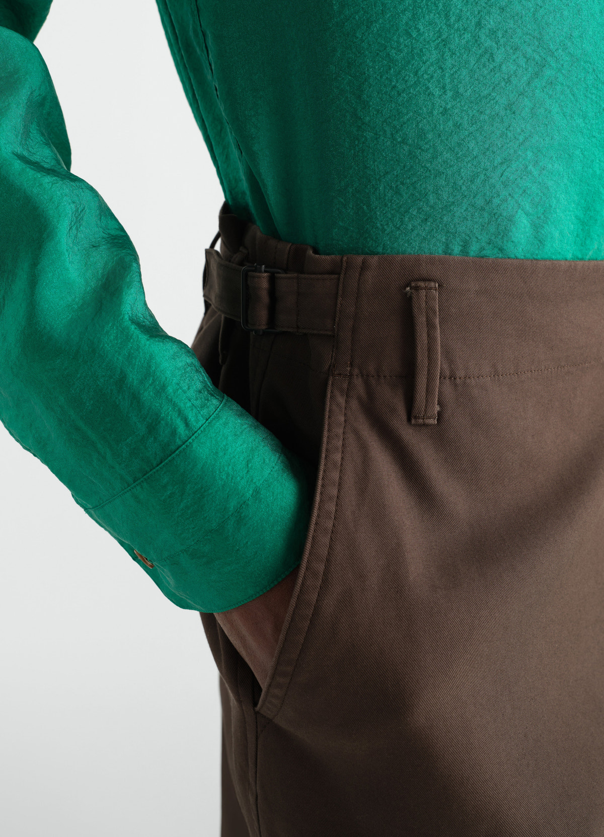Tapered brown heavy cotton twill pants with belt detail worn by model lemaire close-up side shot