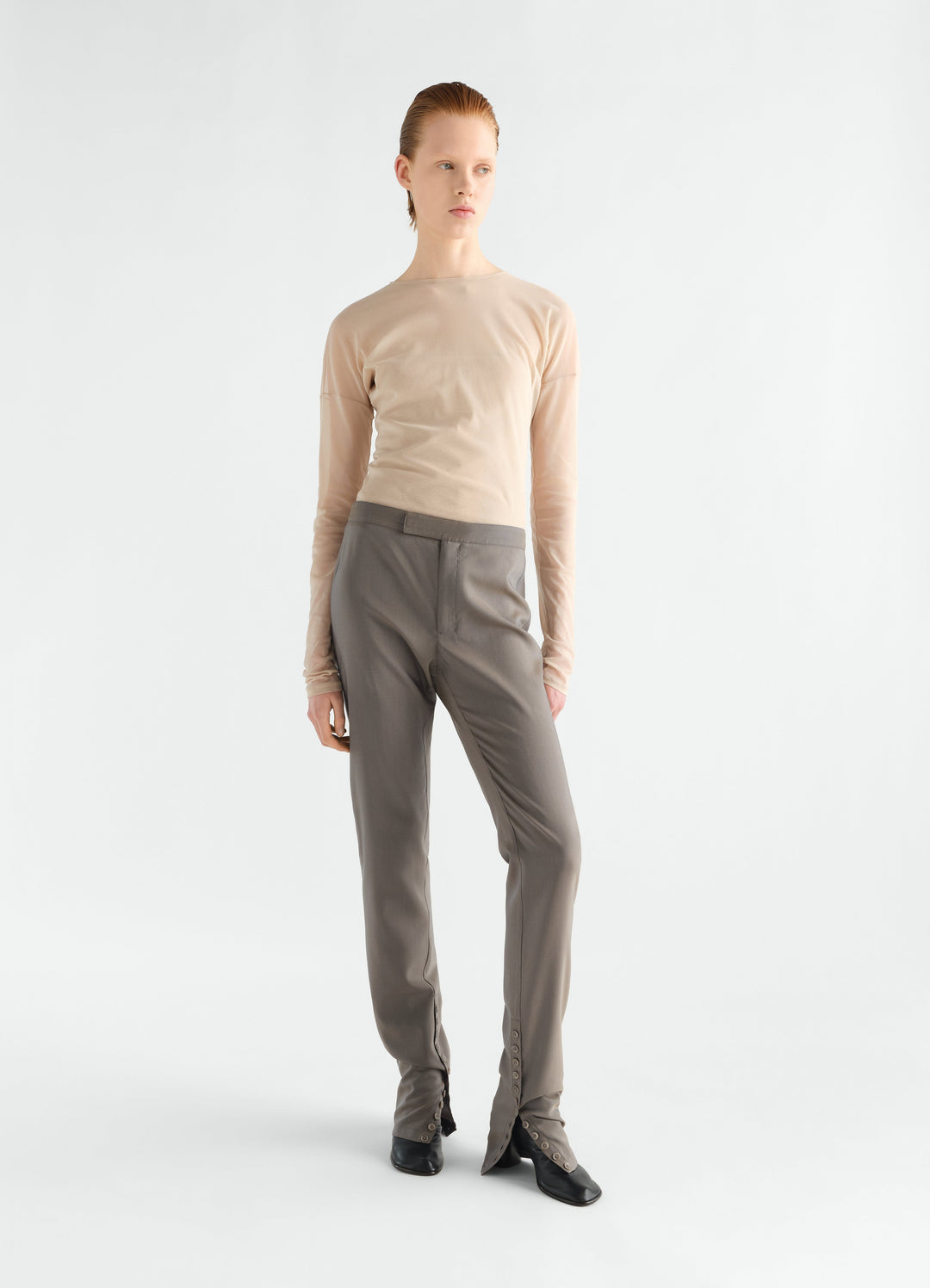 Tailored grey wool mohair pants with buttoned integrated gaiters worn by model LEMAIRE full body front view
