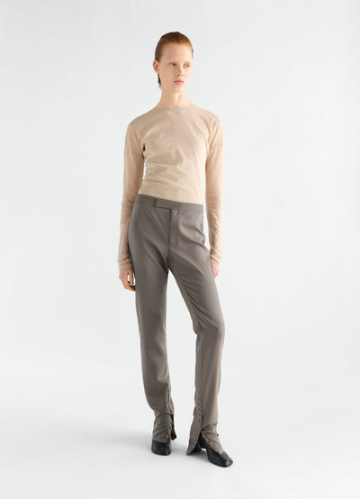 Tailored grey wool mohair pants with buttoned integrated gaiters worn by model LEMAIRE full body front view