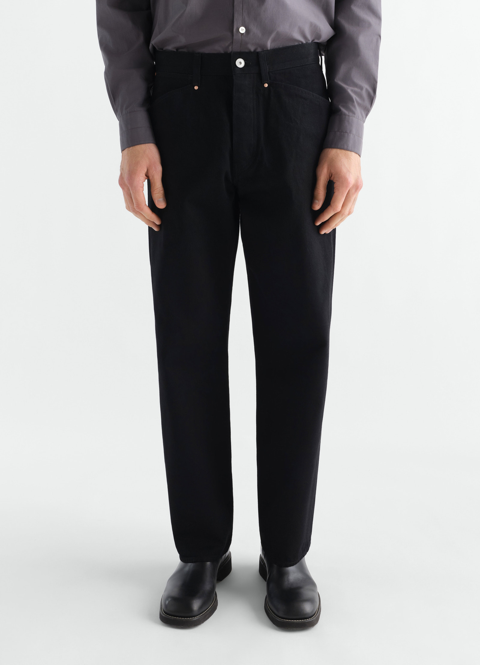 Straight black selvedge denim pants lemaire worn by model front view with visible button and pockets