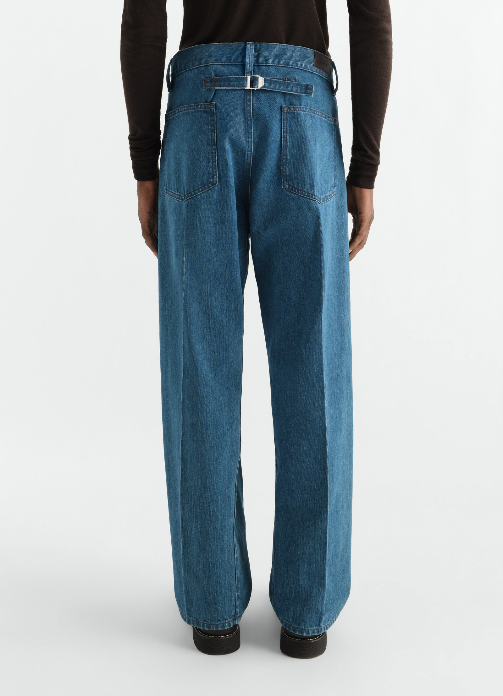 Straight five-pocket indigo selvedge denim pants with belt detail lemaire worn by model back view