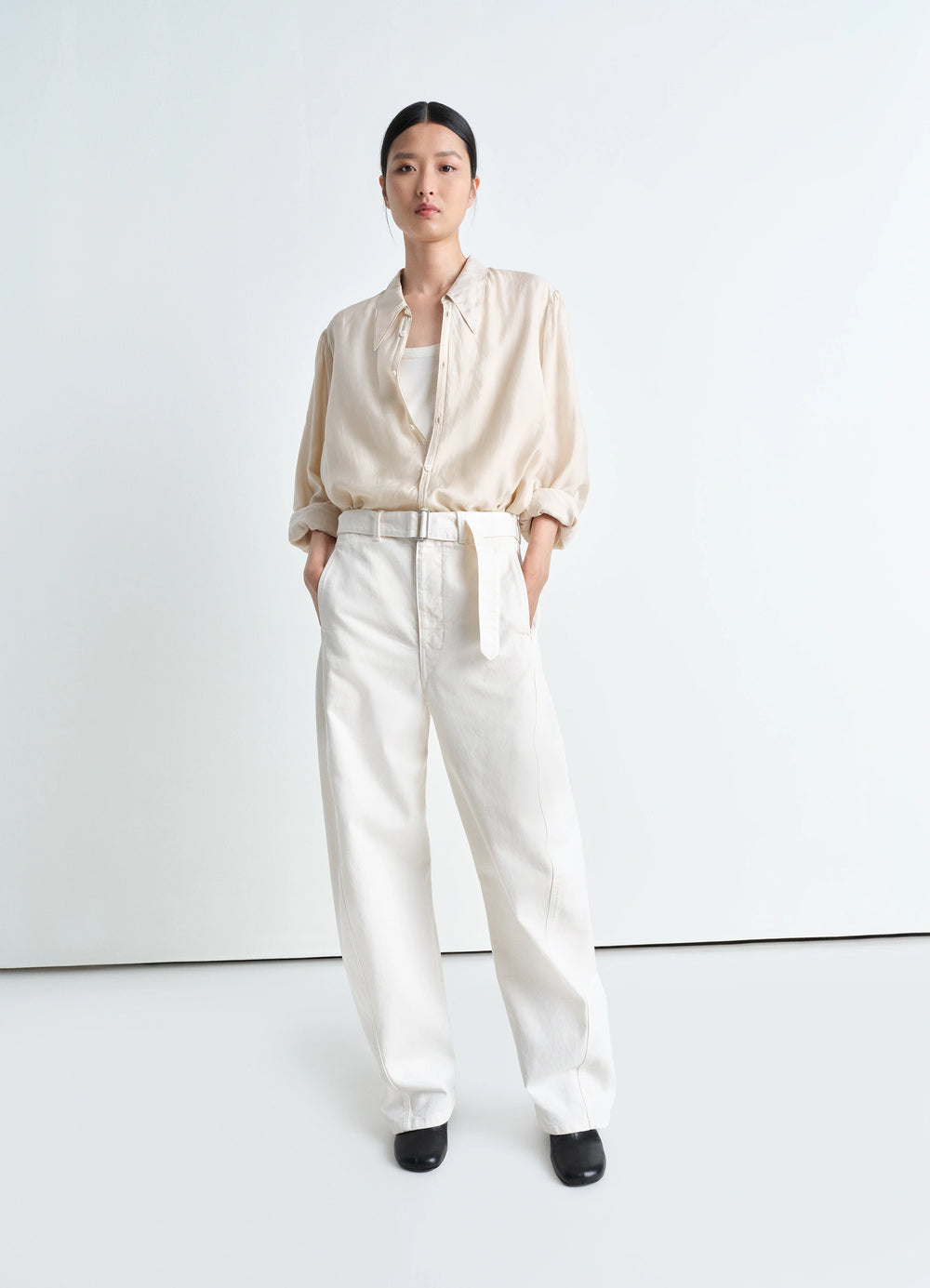 Lemaire Twisted Belted Pants in Garment Dyed Snow Heavy Denim, model shot, side view belted waist, straight cut