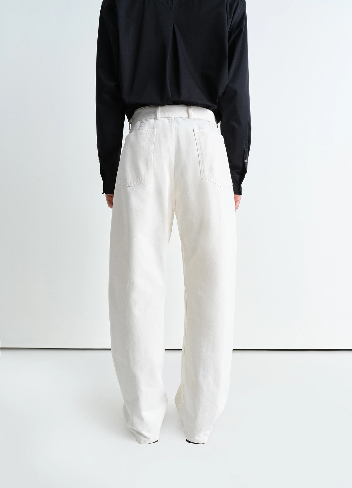 Lemaire twisted belted pants in garment dyed snow heavy denim, model shot, back view straight relaxed fit