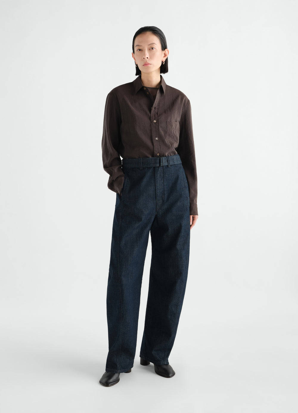 Twisted belted denim pants in dark blue cotton worn by model front view LEMAIRE