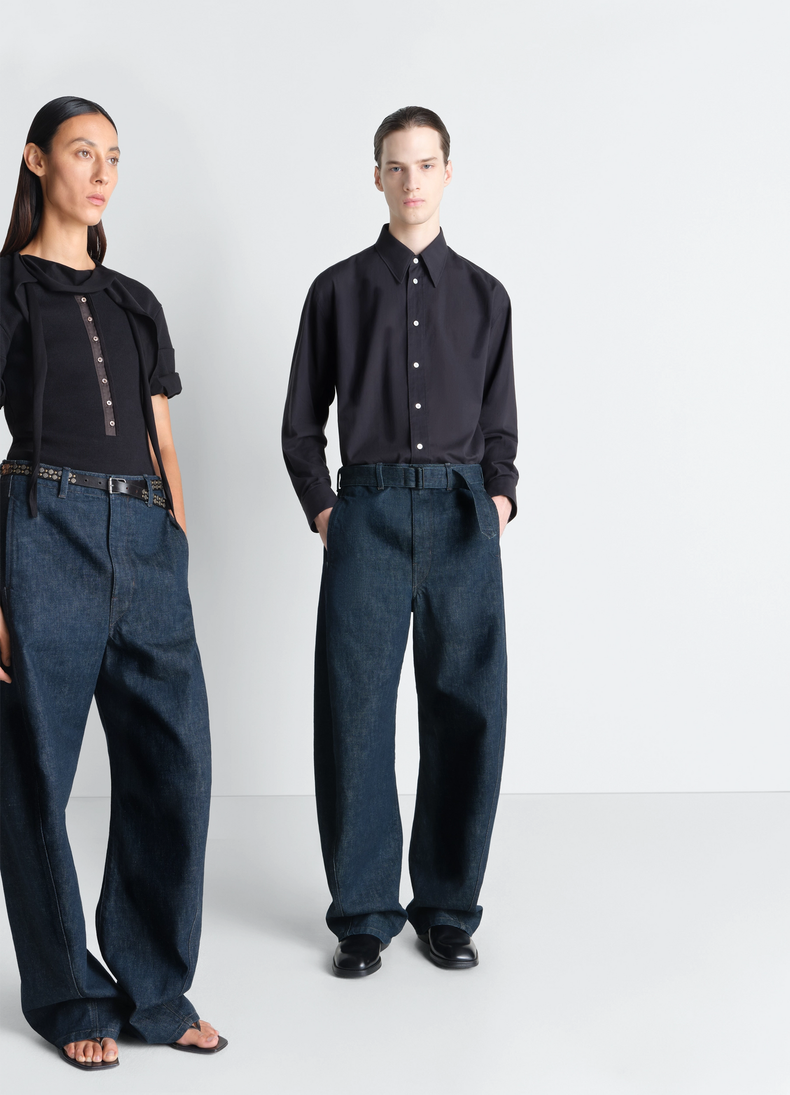 Twisted belted pants in denim in deep indigo garment-dyed denim, model shot, front view twisted seams wide leg