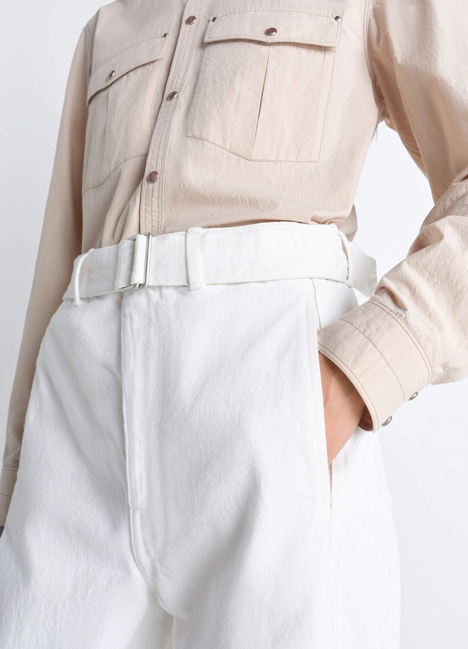Twisted belted pants in denim in bleached denim, model shot, detail close-up belted high waist