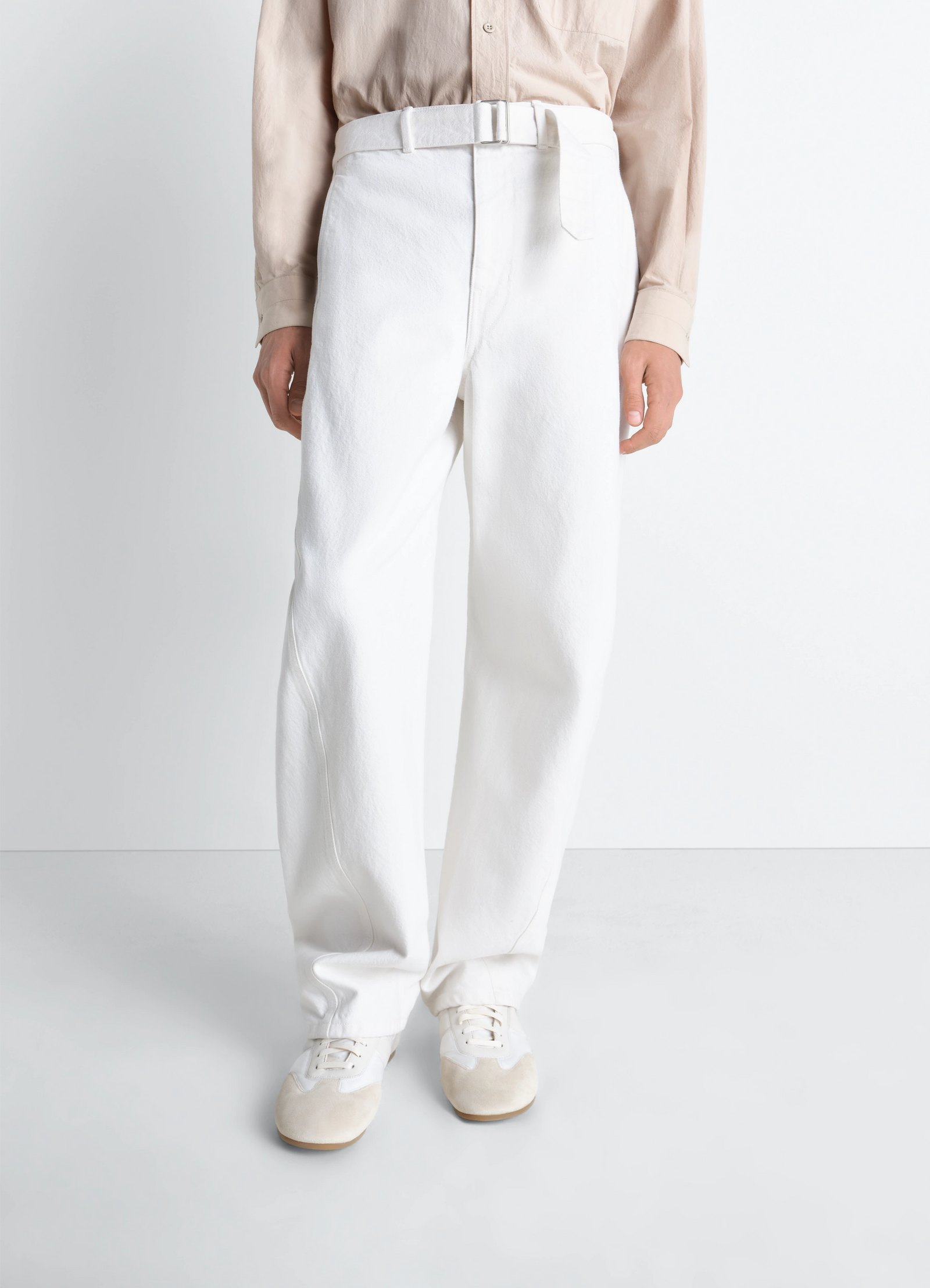 Twisted belted pants in denim in bleached denim, model shot, side view tapered leg