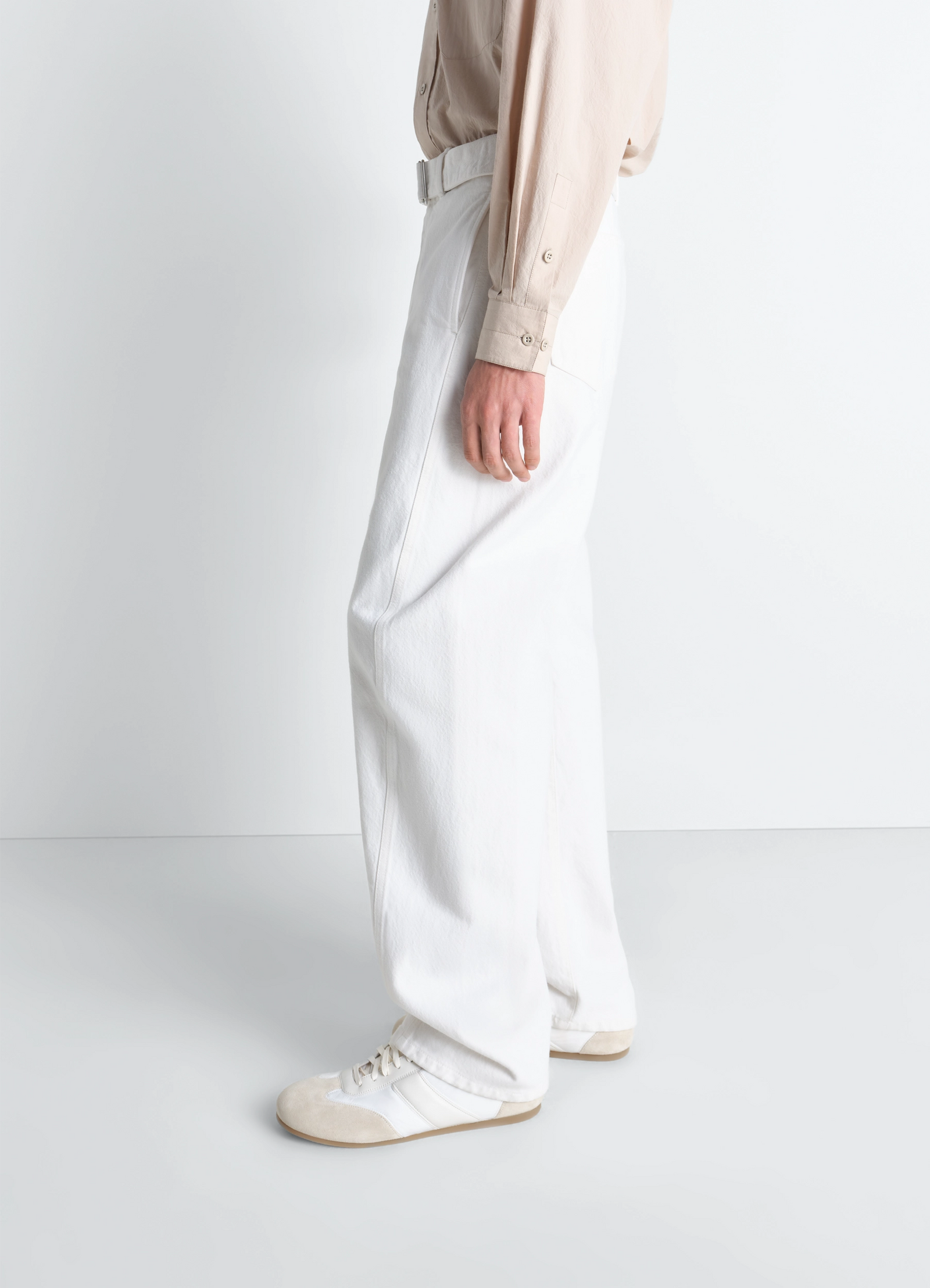 Twisted belted pants in denim in bleached denim, model shot, back three-quarter view unisex, relaxed slouchy fit