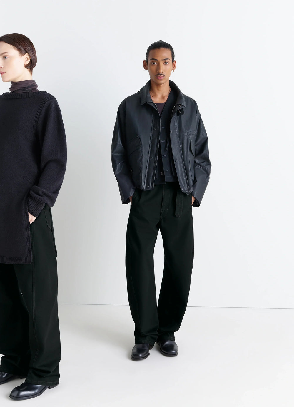 Lemaire Twisted Belted Pants in Deep Black Thick Denim, model shot, Front view Twisted seams rounded leg