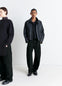 Lemaire Twisted Belted Pants in Deep Black Thick Denim, model shot, Front view Twisted seams rounded leg