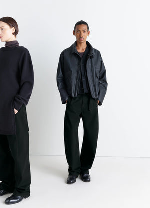 Lemaire Twisted Belted Pants in Deep Black Heavy Denim, model shot, Front view Curved leg, mid-rise