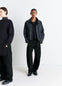 Lemaire Twisted Belted Pants in Deep Black Heavy Denim, model shot, Front view Curved leg, mid-rise