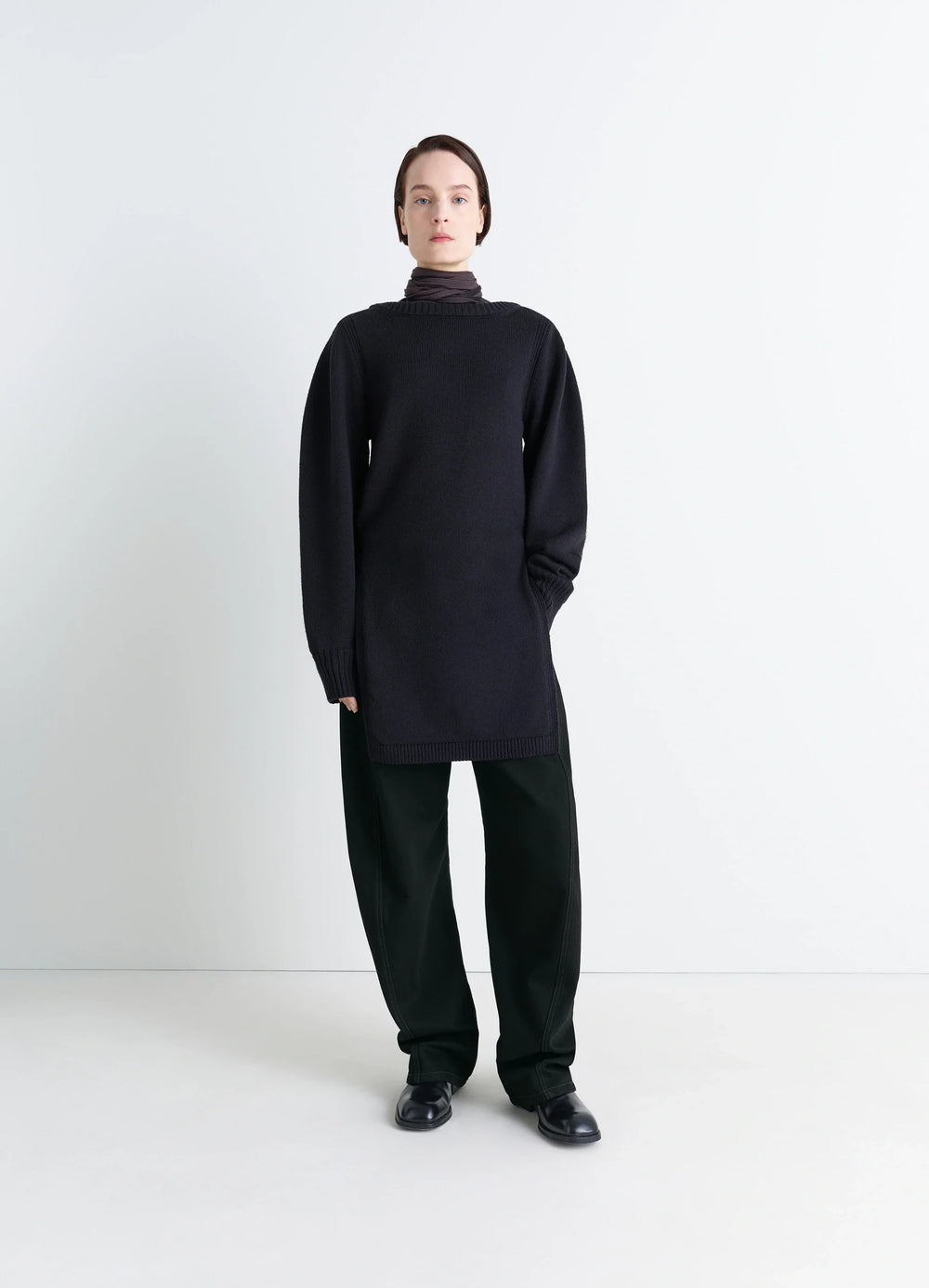Lemaire Twisted Belted Pants in Deep Black Thick Denim, model shot, porte partial front loose fit long hem