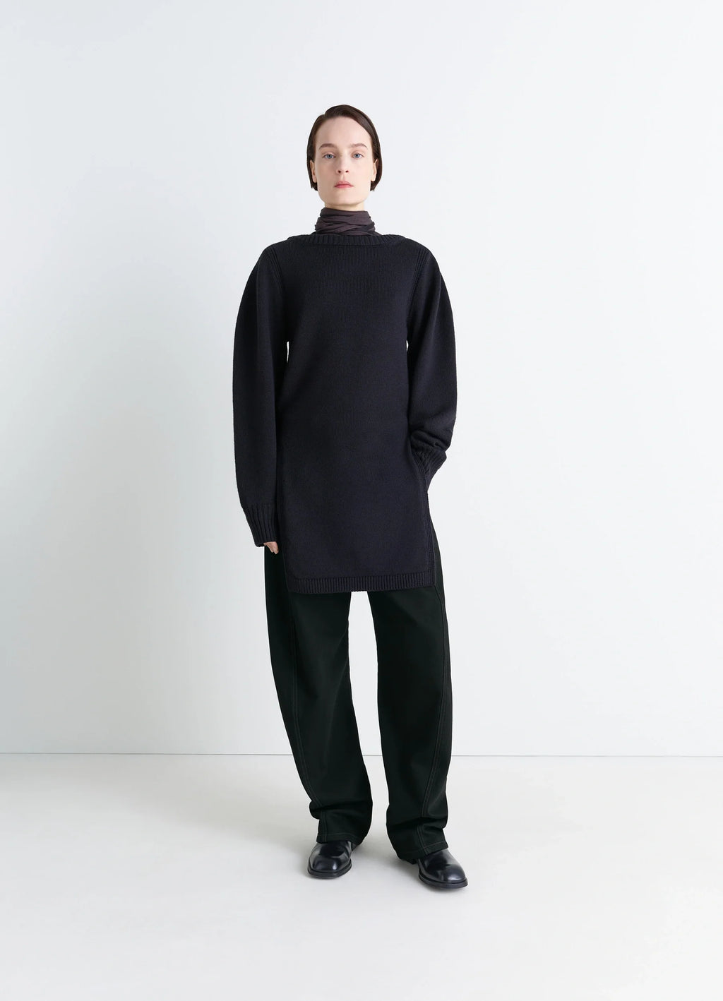 Lemaire Twisted Belted Pants in Deep Black Thick Denim, model shot, porte partial front loose fit long hem
