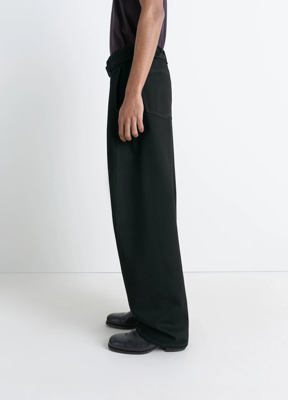 Lemaire Twisted Belted Pants in Deep Black Thick Denim, model shot, side view twisted seams long length