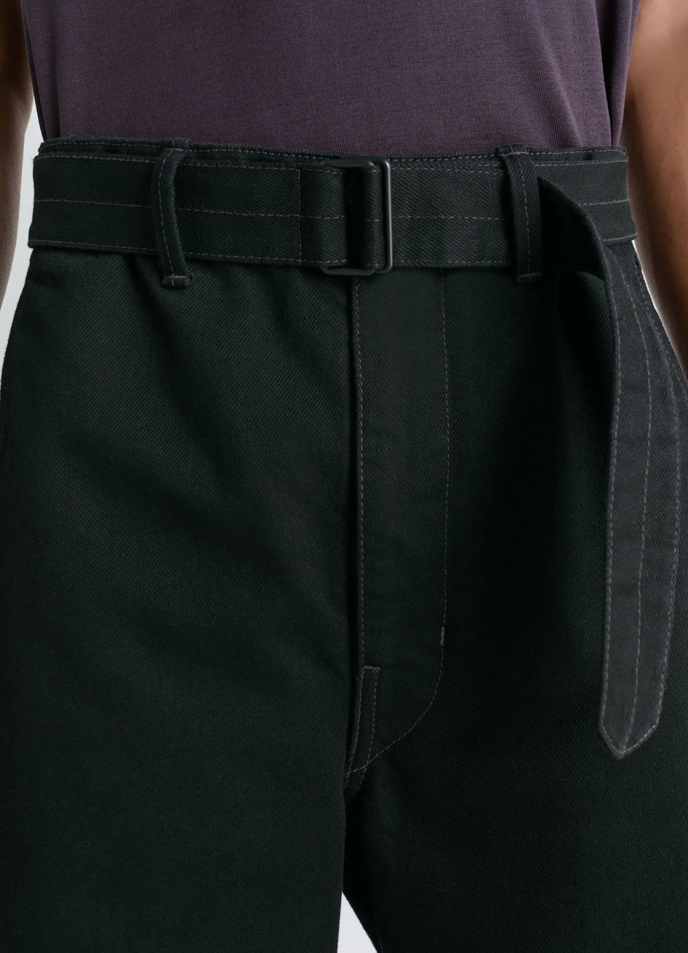 Lemaire Twisted Belted Pants in Deep Black Thick Denim, model shot, belt detail close-up thick denim belted waist