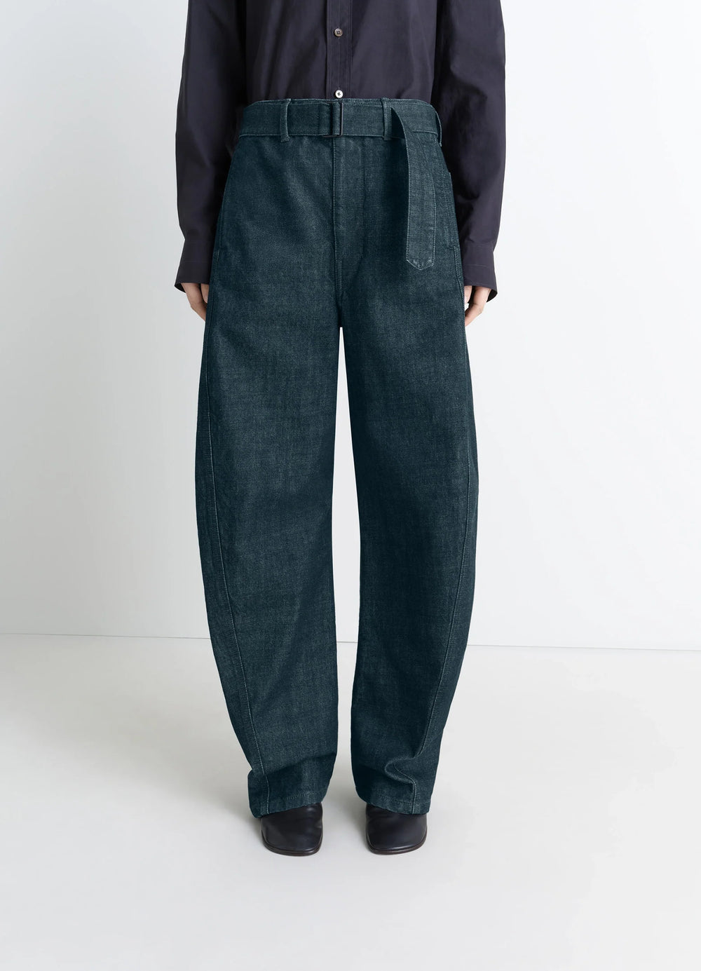 Lemaire Twisted Belted Pants in Deep Indigo Heavy Denim, model shot, three-quarter view high waist with belt