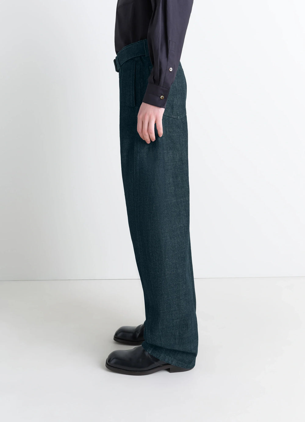 Lemaire Twisted Belted Pants in Deep Indigo Heavy Denim, model shot, side profile view loose fit worn with shirt