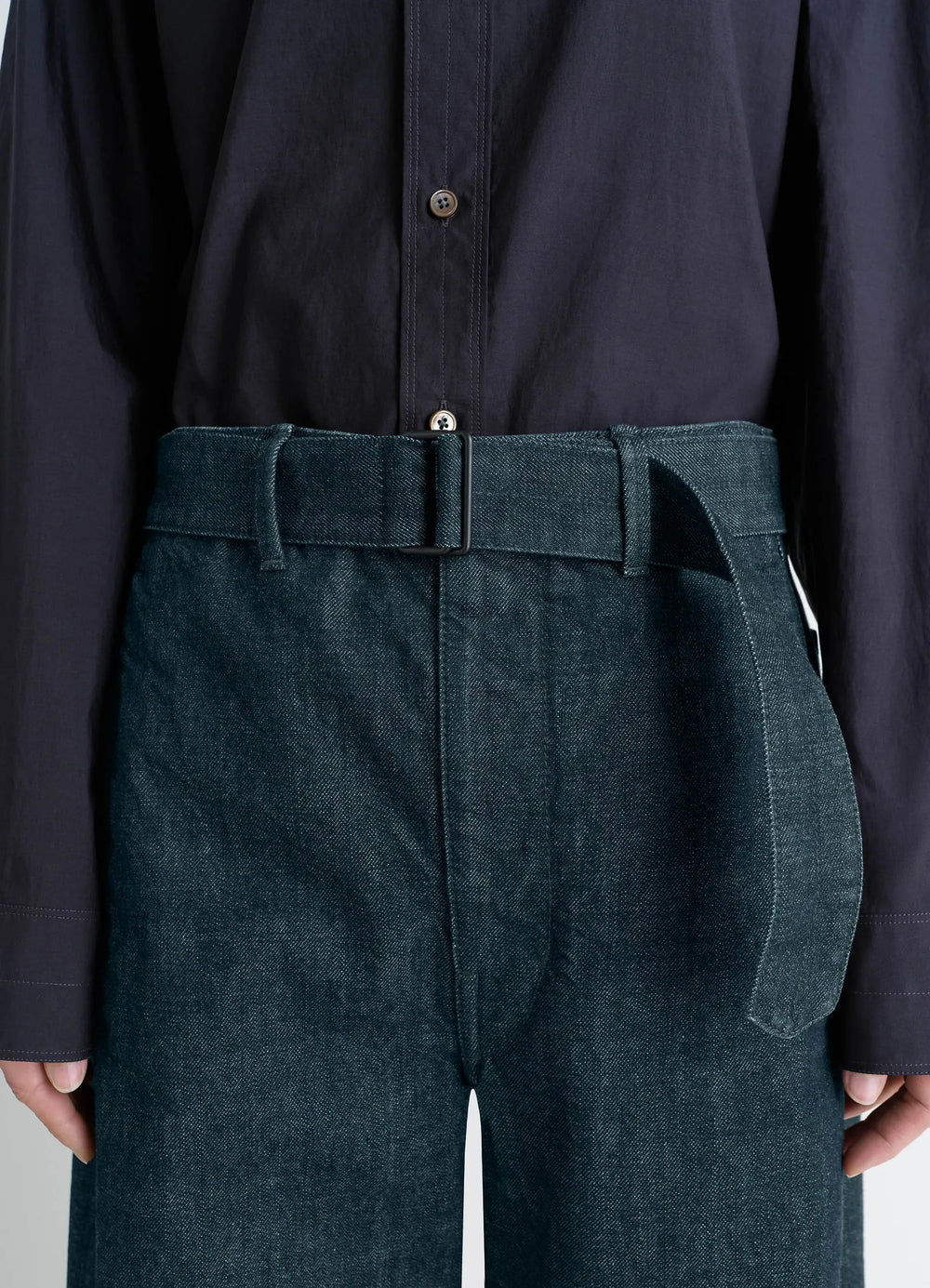 Lemaire Twisted Belted Pants in Deep Indigo Heavy Denim, model shot, waist detail view high-rise detail with belt