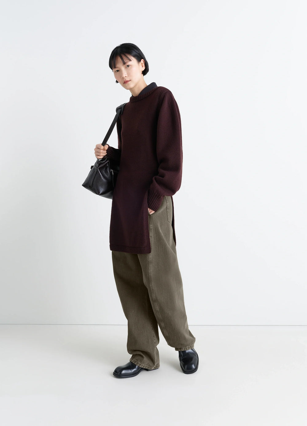 Lemaire Twisted Belted Pants in Snowy Patina Thick Denim, model shot, side view loose fit unisex