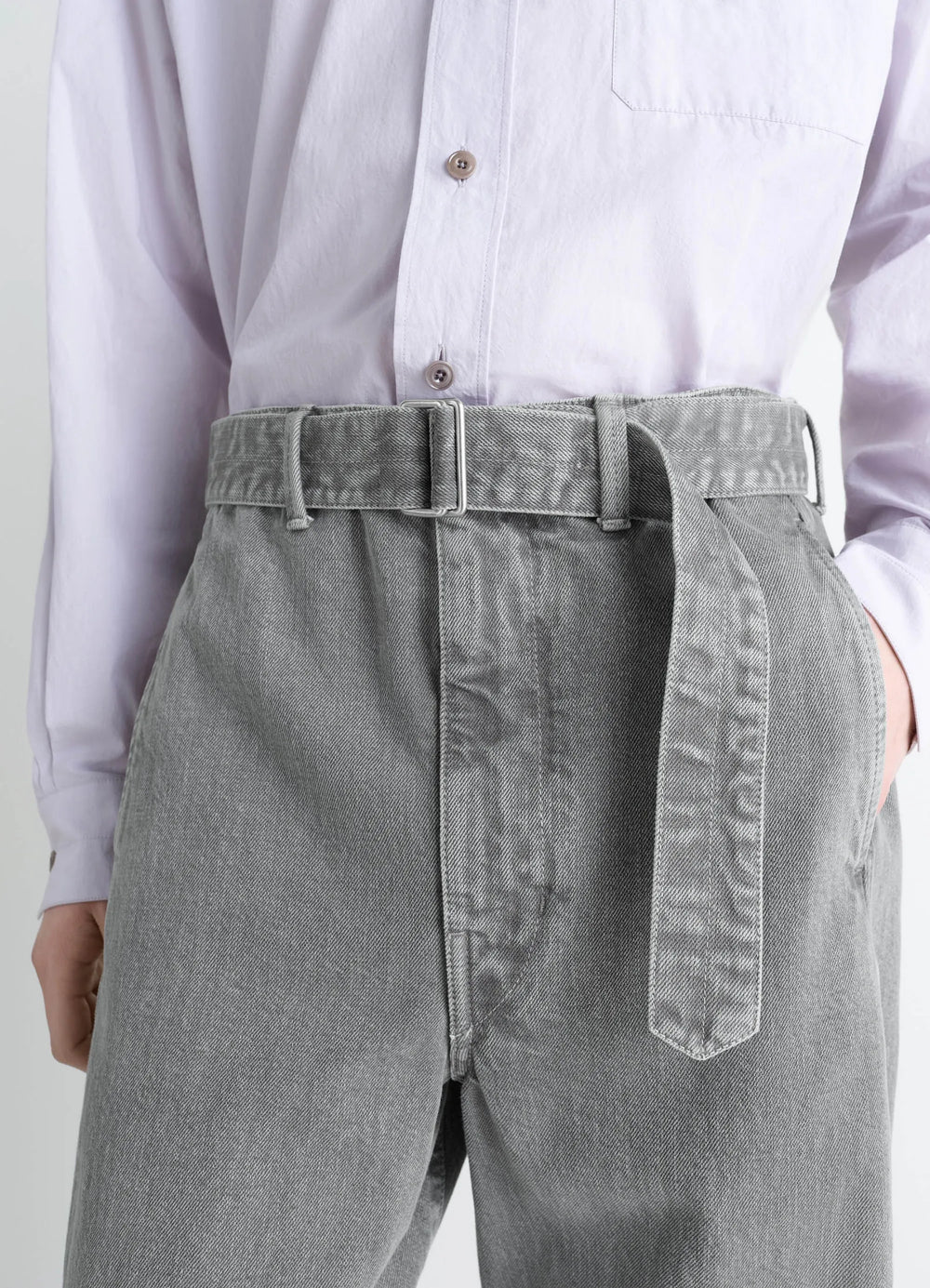 Lemaire Twisted Belted Pants in Snowy Patina Thick Denim, model shot, waist-up close-up view belt detail visible