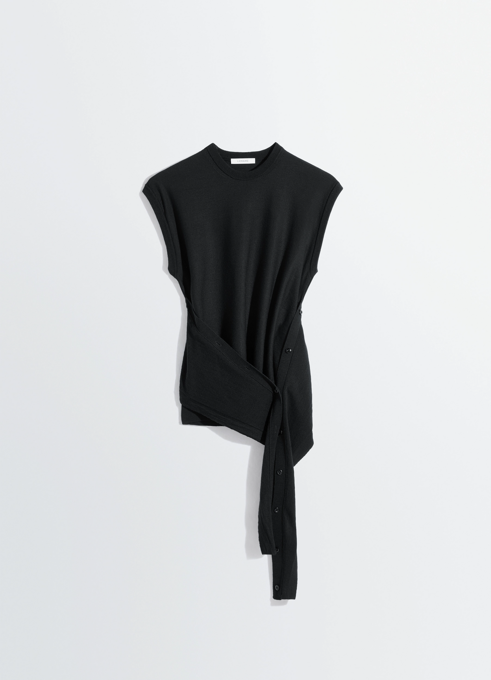 Sleeveless buttoned top in black merino blend, product shot, angled overhead view wrap button detail