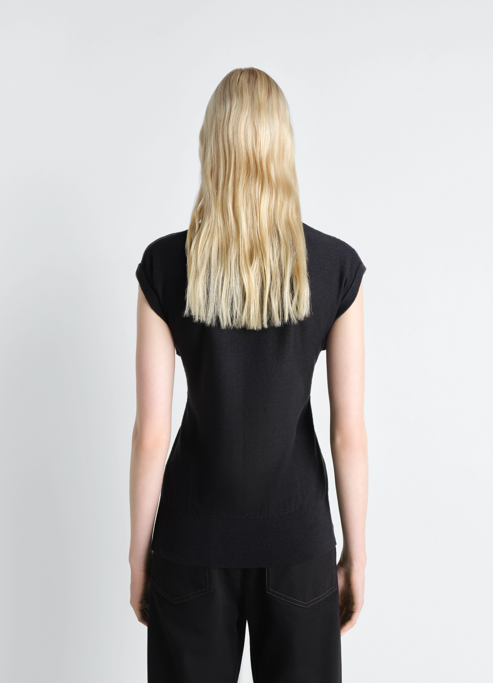 Sleeveless buttoned top in black merino blend, model shot, back view cap sleeves