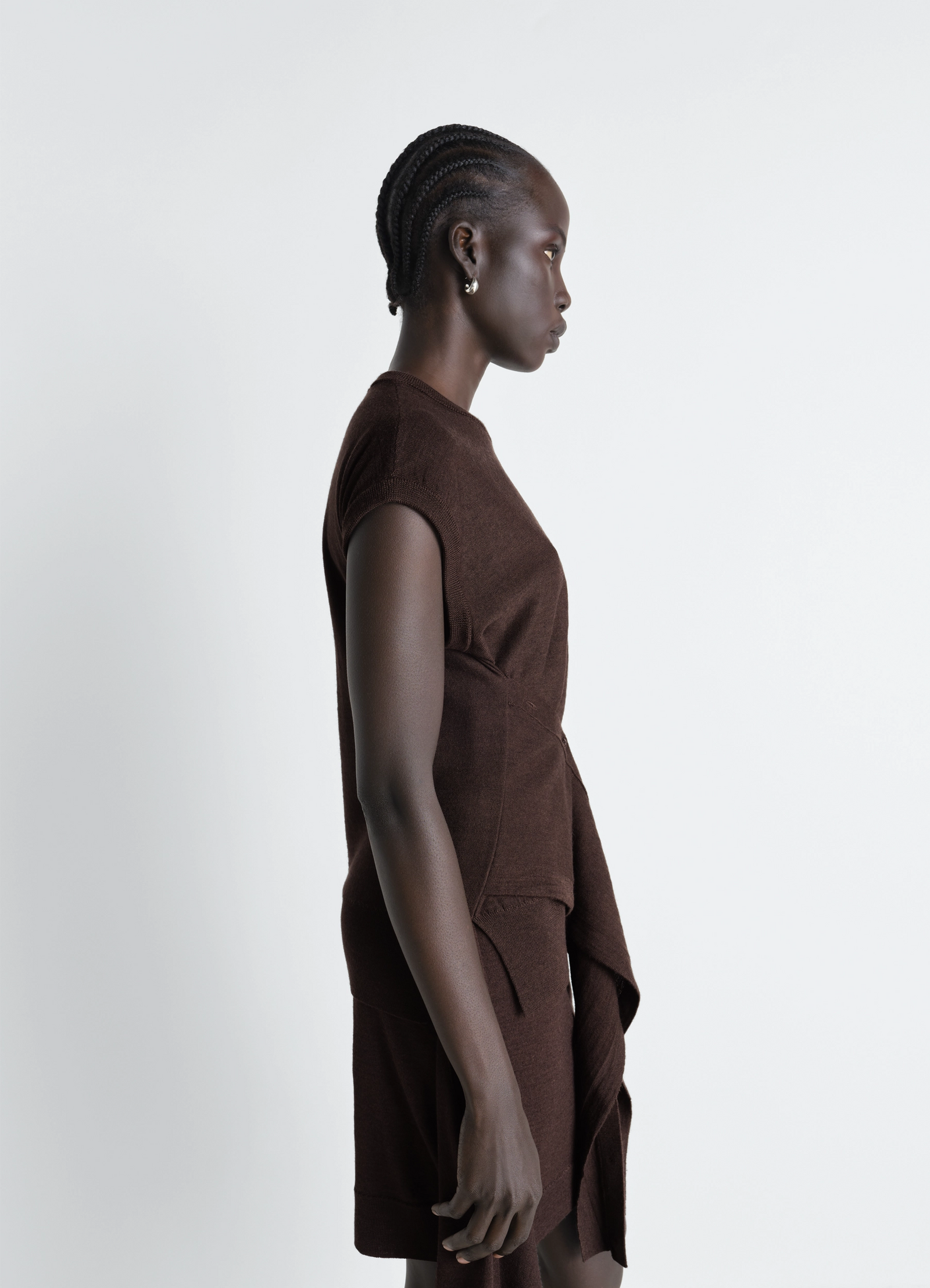 Lemaire sleeveless buttoned top in brown merino blend, model shot, three-quarter view fitted bodice