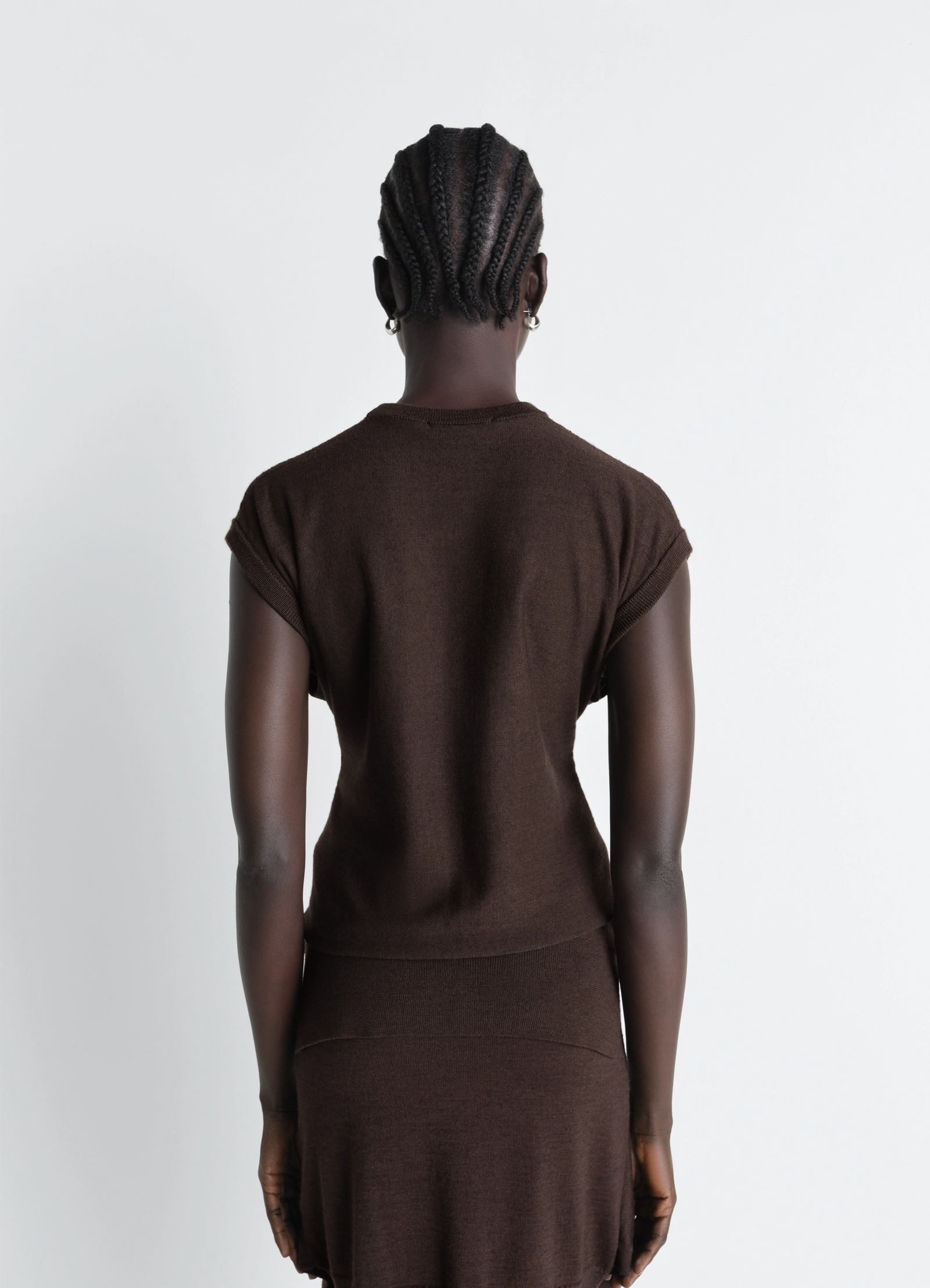 Lemaire sleeveless buttoned top in brown merino blend, model shot, back view rolled sleeve edges