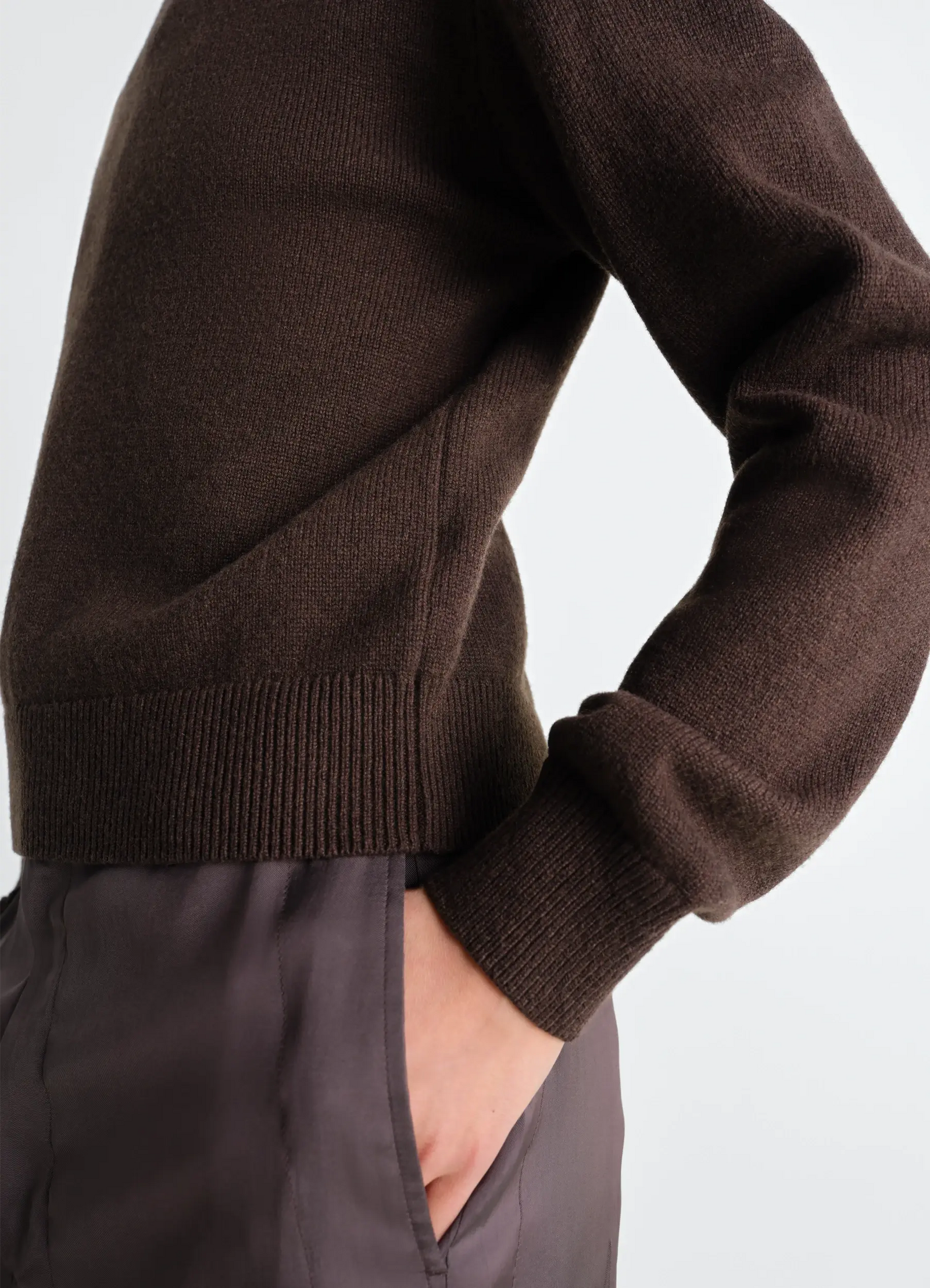 Lemaire reversible buttoned sweater in cashmere wool, model shot, close-up side view ribbed sleeve and hem