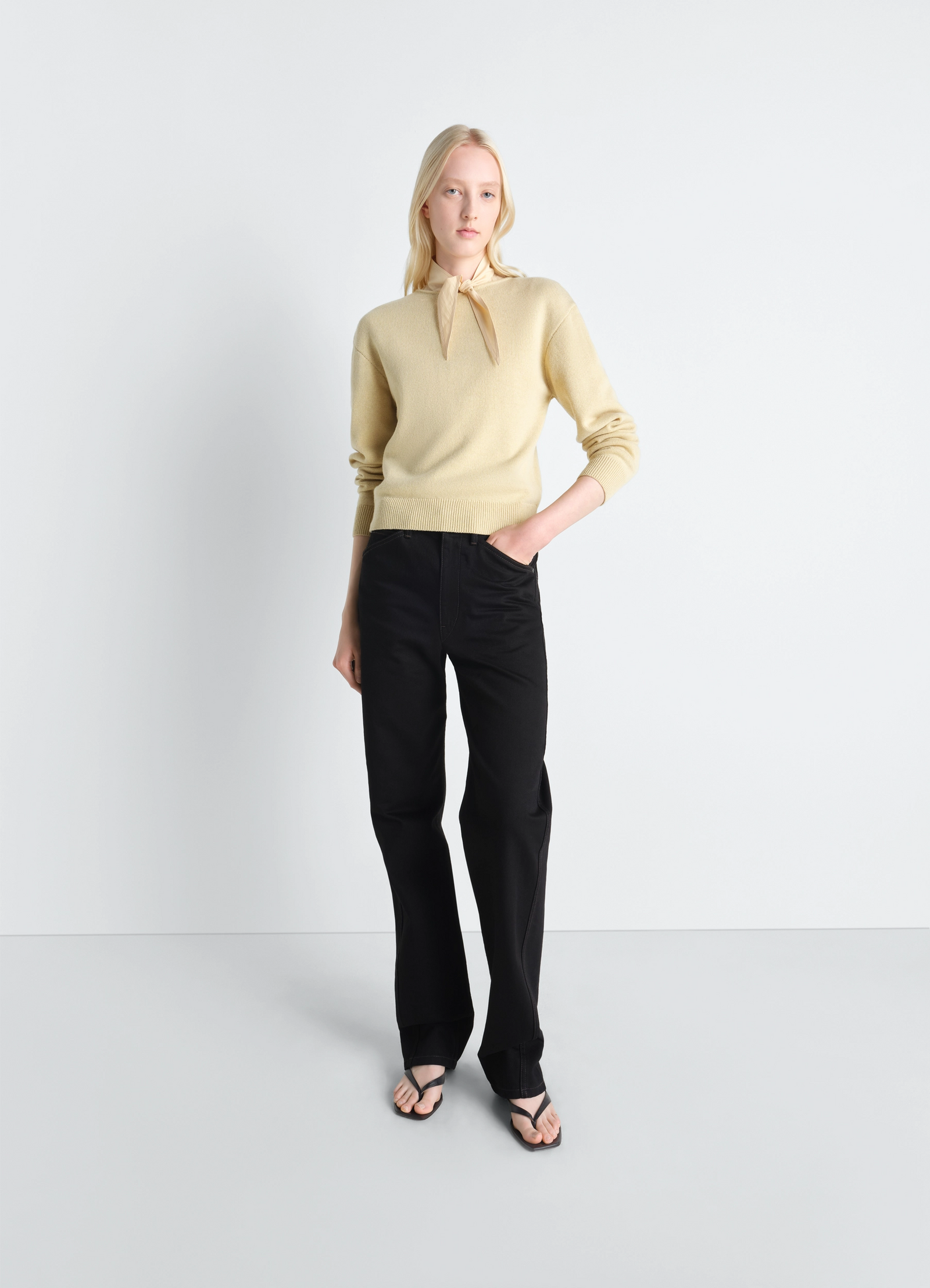 Lemaire reversible buttoned sweater in cashmere wool, model shot, three-quarter view scarf-tied neck