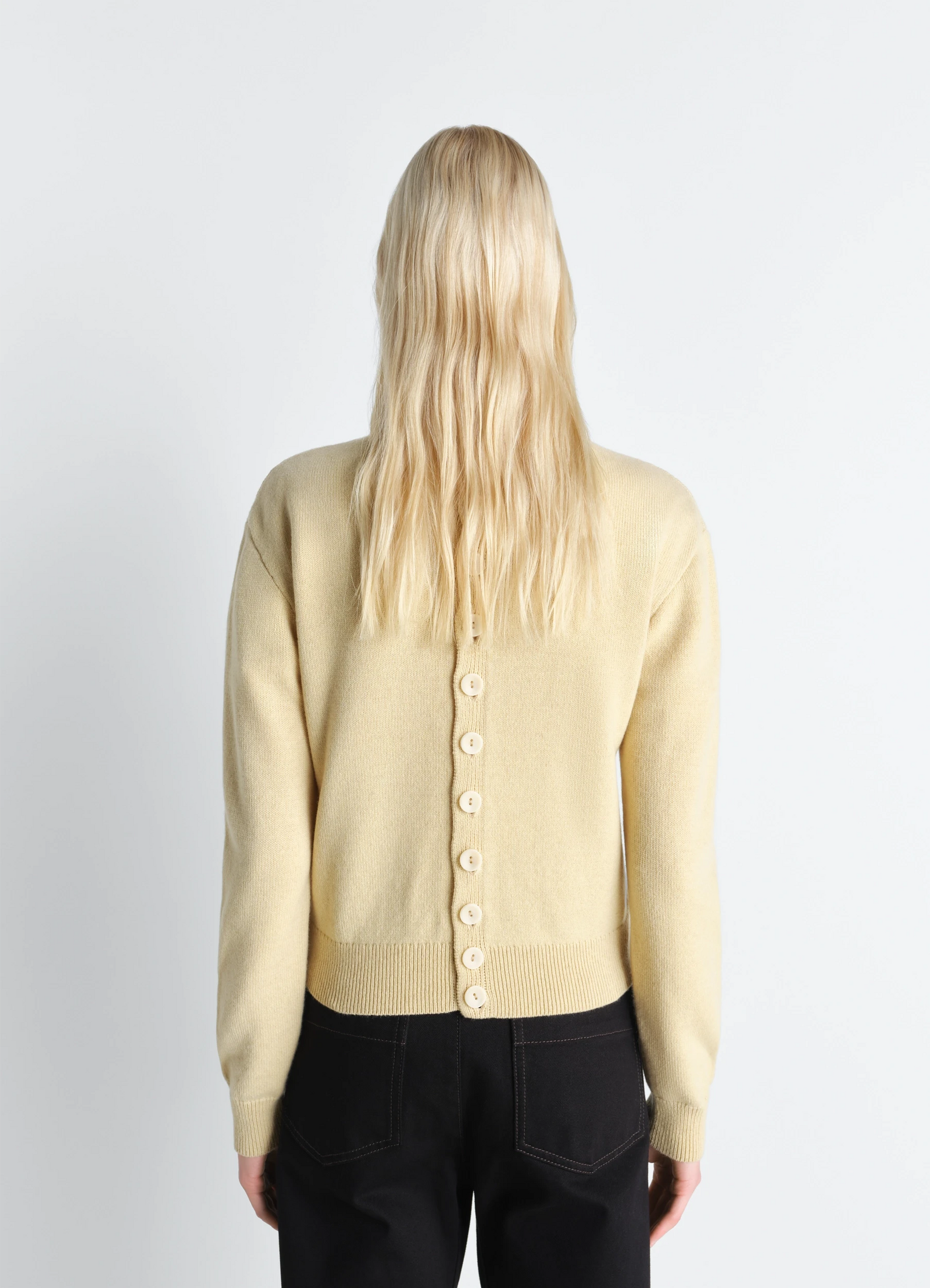 Lemaire reversible buttoned sweater in cashmere wool, model shot, back detail view button-back with ribbed hem
