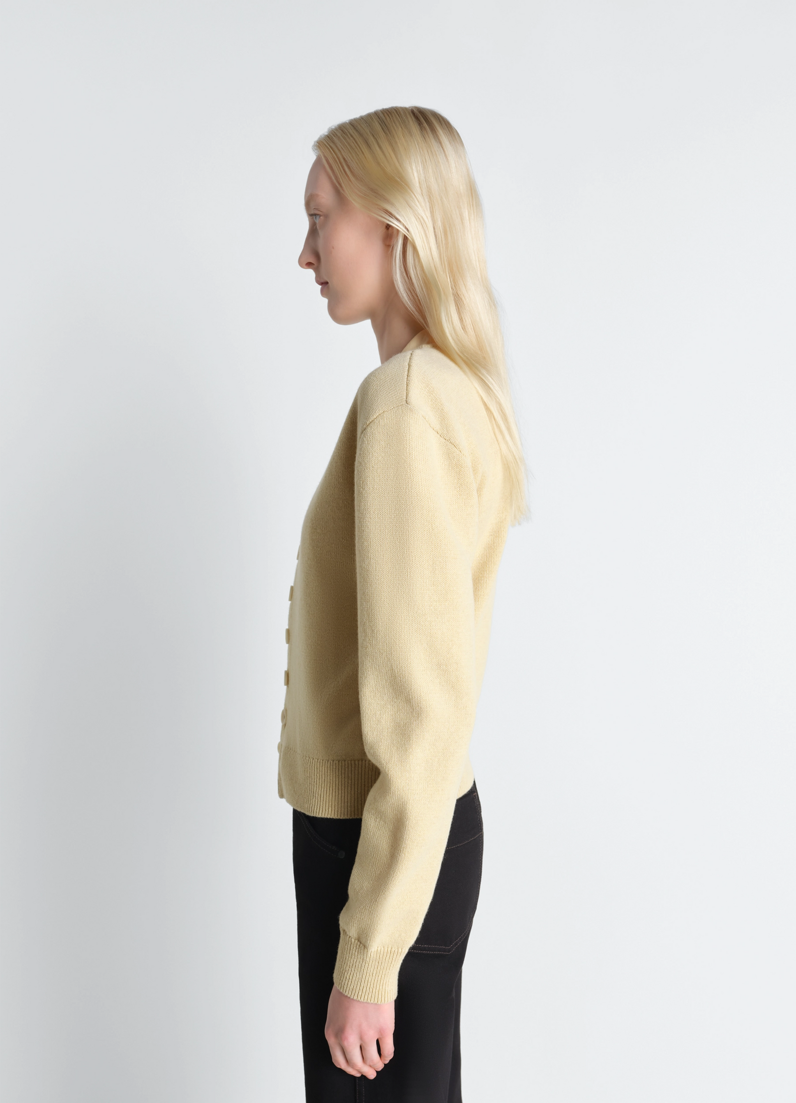 Lemaire reversible buttoned sweater in cashmere wool, model shot, side view ribbed hem and cuffs