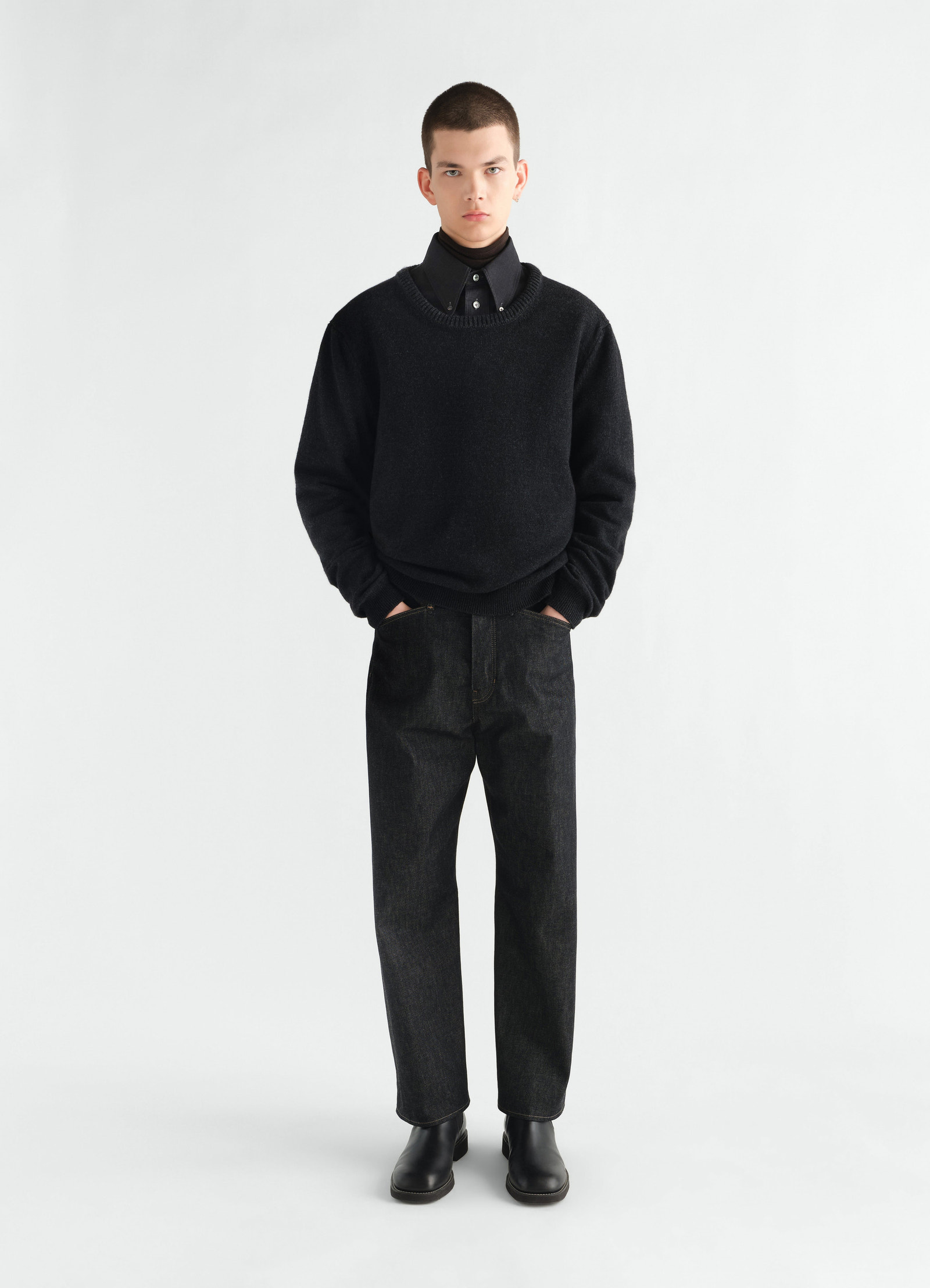 Crew-neck black alpaca wool blend sweater lemaire worn by model front view with hands in pockets