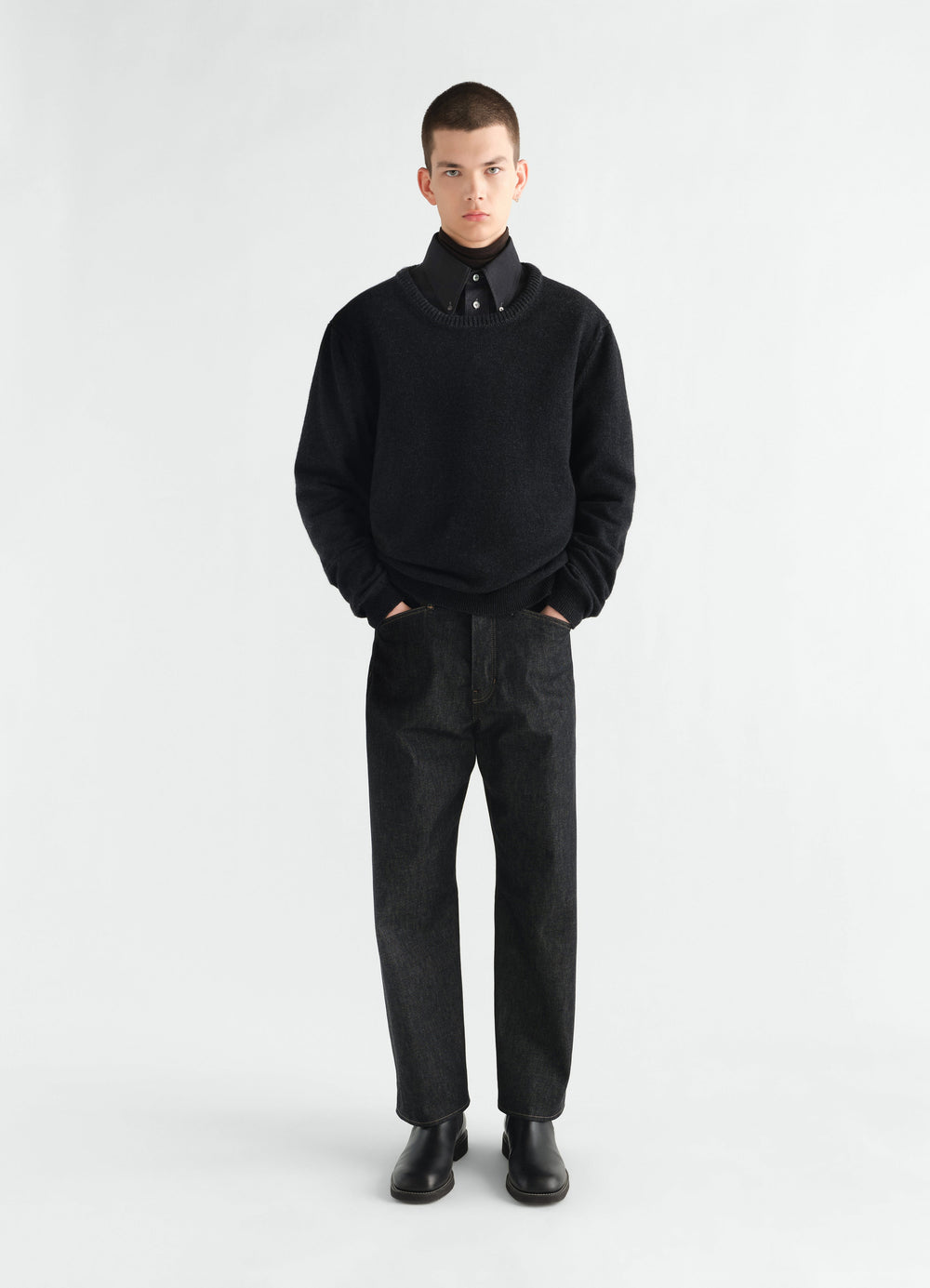 Crew-neck black alpaca wool blend sweater LEMAIRE worn by model front view with hands in pockets